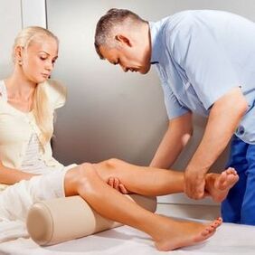 Doctor examining patient's knee joint